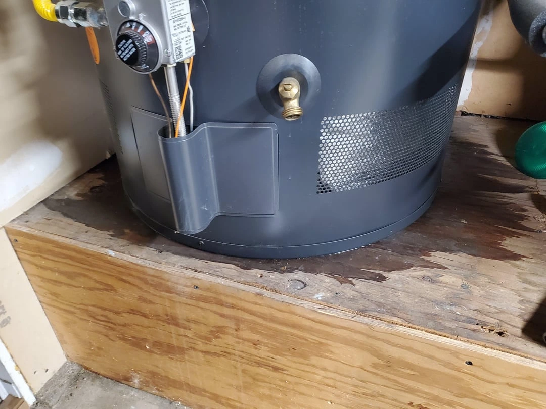 Water pooling under a failed water heater tank during an emergency call in Lancaster, PA