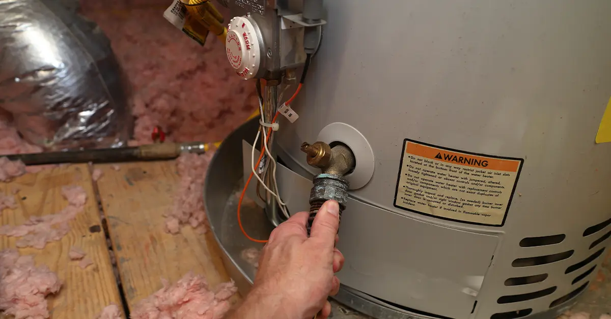 Attaching a hose to the drain valve to flush sediment from a water heater in Lancaster, PA