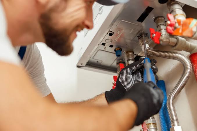 Lancaster Water Heater Pros technician servicing a water heater in a Lancaster, PA home
